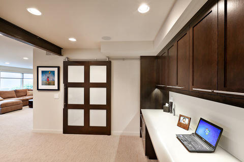 Contemporary Home Office with darkly stained shaker style cabinets
