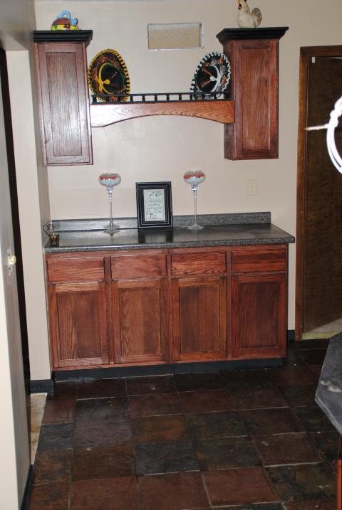 Traditional Bar with dark wood stained cabinets