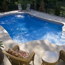 Traditional Pool with wicker towel hamper in shape of pineapple