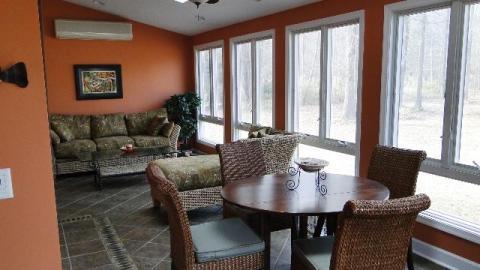 Traditional Sunroom with rattan chairs with high backs