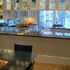 Transitional Dining Room with white wood kitchen cabinets