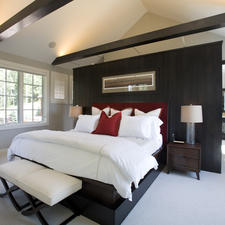Contemporary Bedroom with stained wood ceiling beams