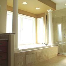 Transitional Master Bathroom with gold painted accent wall