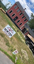 Logo for New Era Exterior Construction