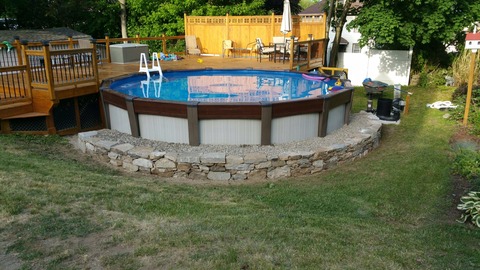 Transitional Pool with medium stained pool deck