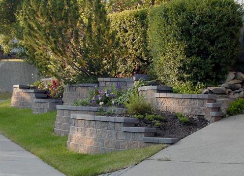 Transitional Landscape with cement brick raised flower beds