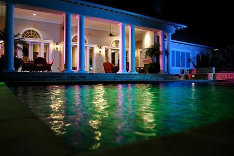 Traditional Pool with white columns around patio