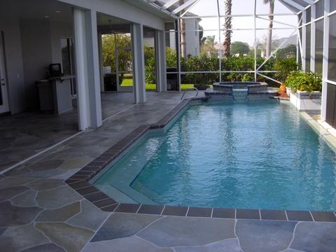 Contemporary Sunroom with slate tiled pool surround