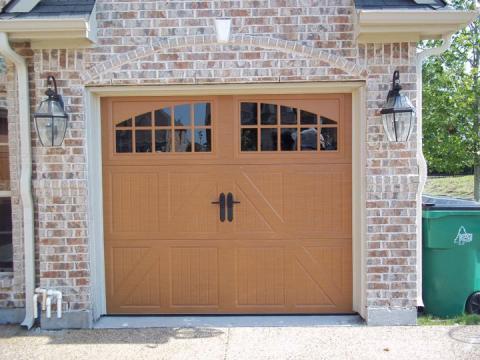 Transitional Garage with carriage style garage door