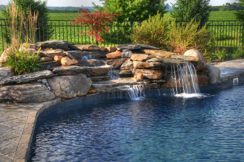 Traditional Pool with traditional style pool with waterfall feature