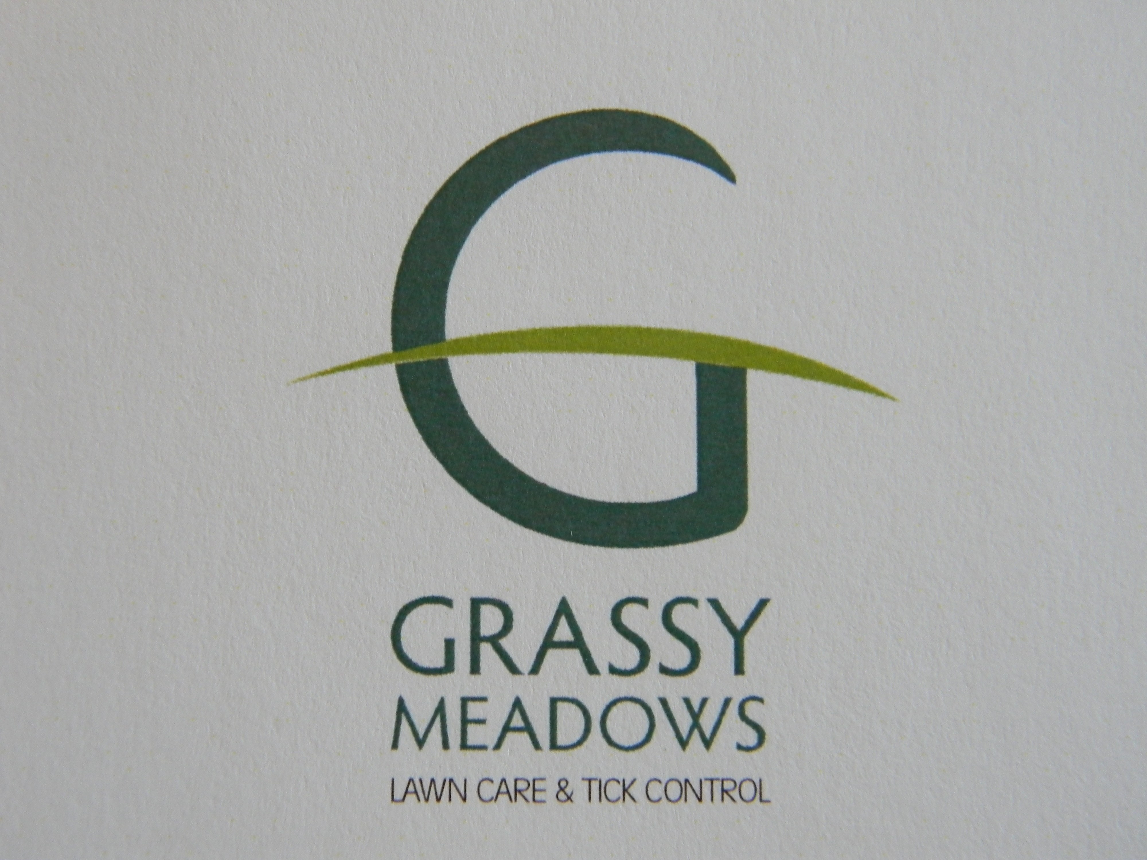 Grassy Meadows Lawn care & Tick Control logo