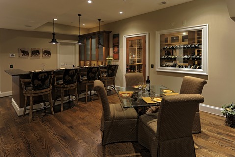Transitional Wine Cellar with dark stained hardwood flooring