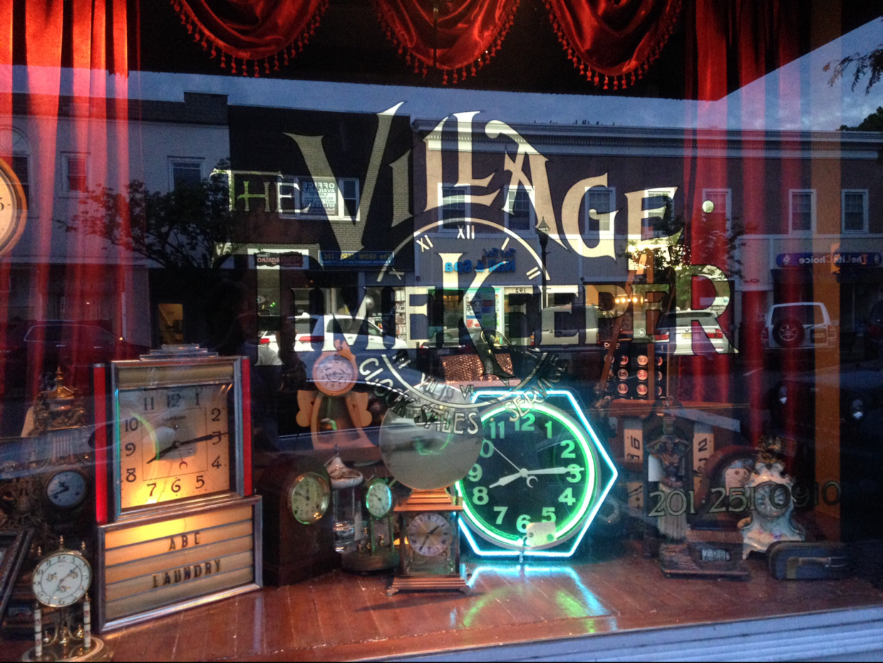 The Village Timekeeper logo