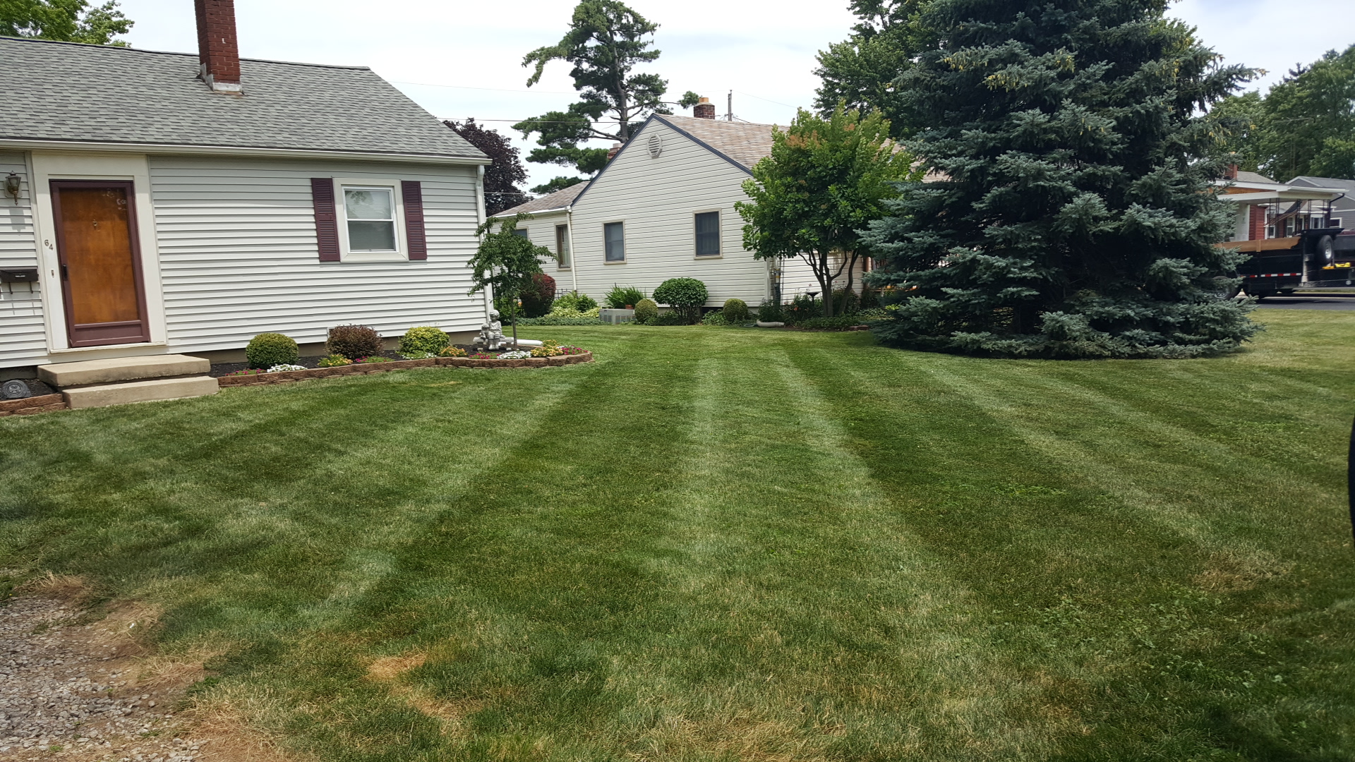 Kuhn's lawn care and property management logo