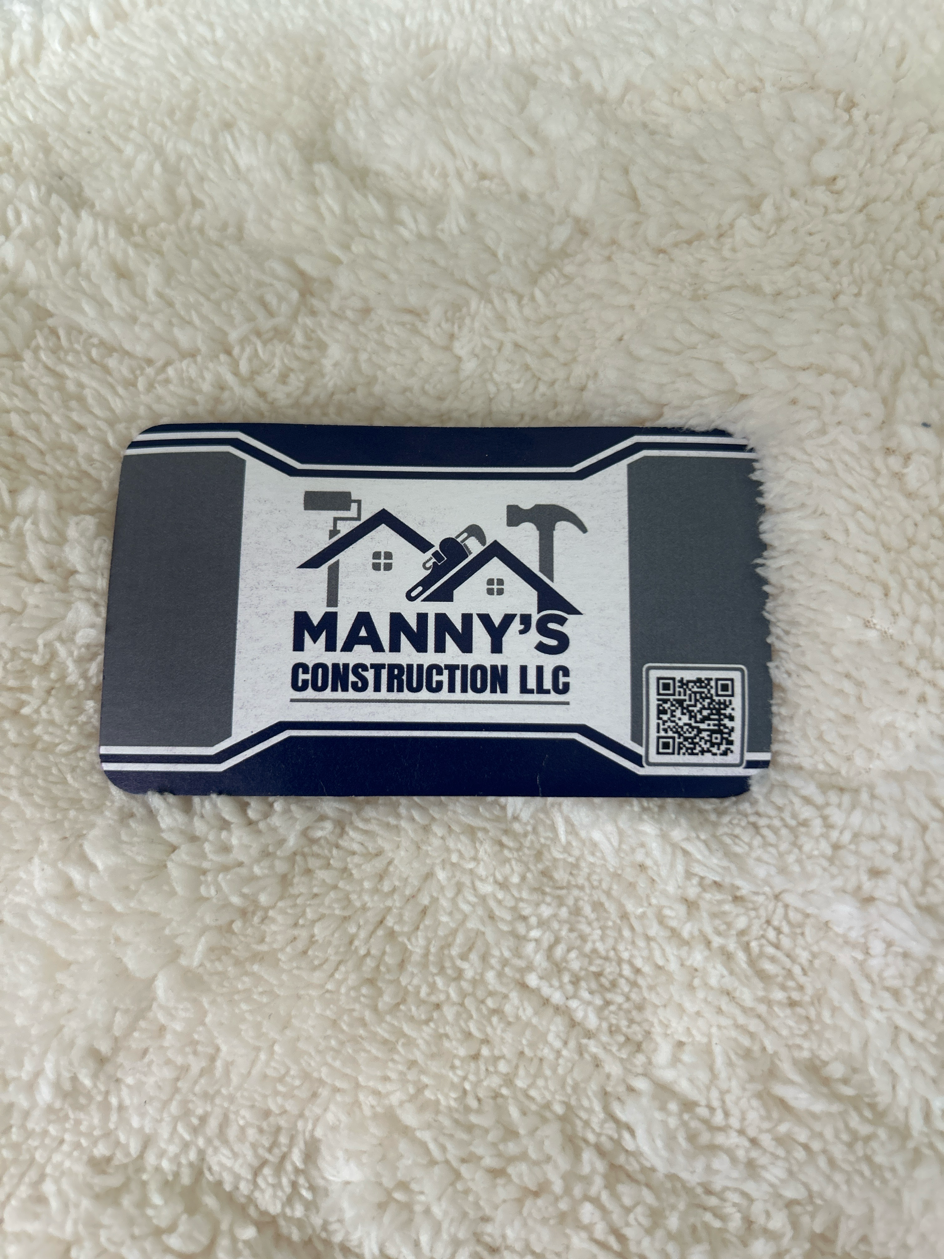 Manny Construction logo