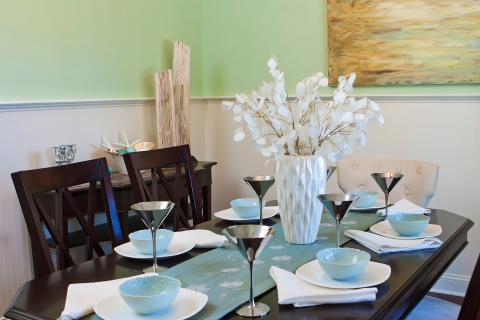 Transitional Dining Room with large white ceramic vase center piece