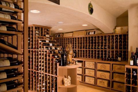 Traditional Wine Cellar with light tan stucco walls and ceiling