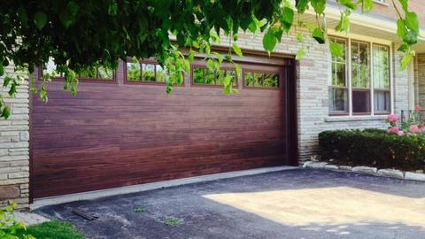 Transitional Garage with faux wood garage door