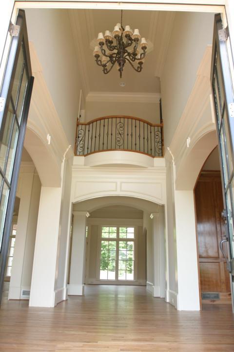 Transitional Entry with large metal chandelier with white shades