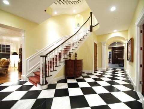 Traditional Staircase with dark wood railing with white balusters