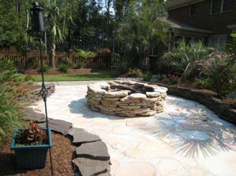 Transitional Landscape with stone slab raised flower bed