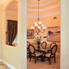 Traditional Dining Room with dark wood dining chairs with tan upholstered seats and backs