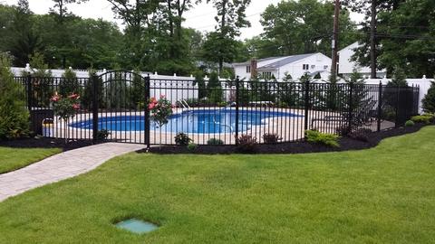 Traditional Pool with white privacy fence