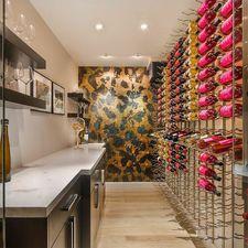 Contemporary Wine Cellar with gold textured accent wall