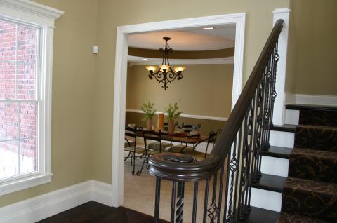 Transitional Staircase with black metal hanging chandelier