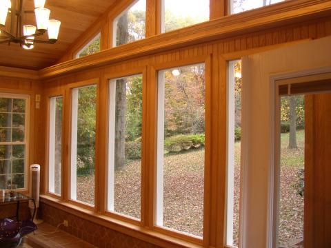 Contemporary Sunroom with light wood paneling