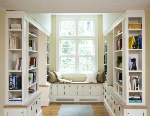 Contemporary Library with built in bench next to the window