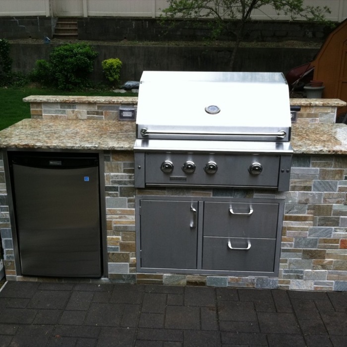 Outdoor kitchenette with grill and mini-fridge