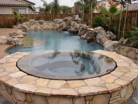 Traditional Pool with slate tile hot tub surround