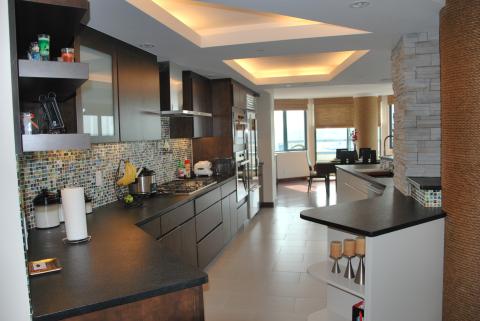 Modern kitchen with long countertops and a tile backsplash