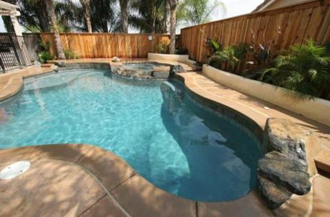 Traditional Pool with tall wooden privacy fence