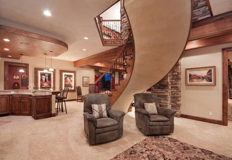 Traditional Basement with wood and iron banister