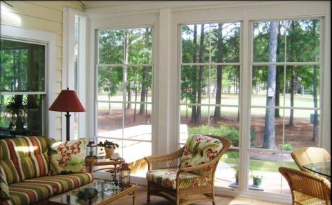 Transitional Sunroom with stripped cushions on wicker furniture