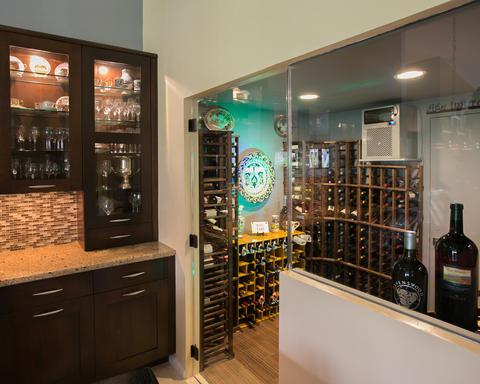 Transitional Wine Cellar with glass mosaic tile backsplash