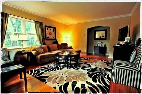Eclectic Family Room with black gold and white area rug