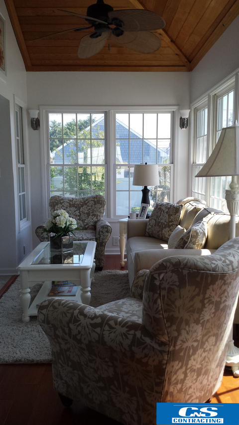 Transitional Sunroom with floral upholstered chairs