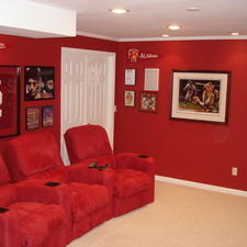 Eclectic Home Theater with red suede theater chairs