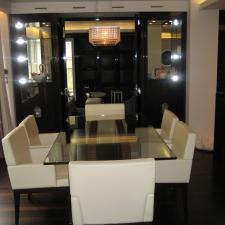 Modern Dining Room with large black built-in china cabinets