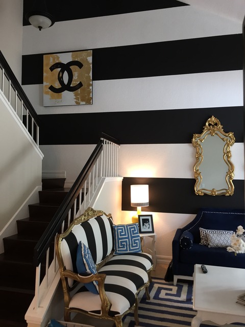 Eclectic Living Room with black and white striped accent wall