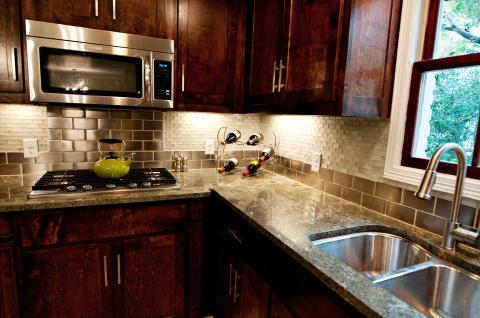 Transitional Kitchen with stainless steel tile back splash