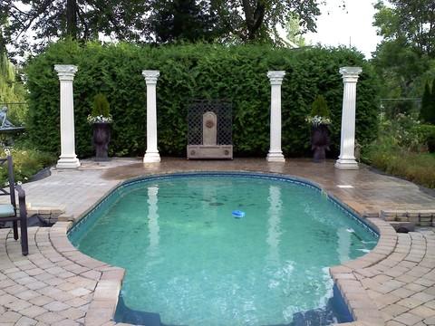 Traditional Pool with cobblestone patio around pool