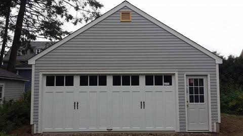 Transitional Garage with white painted garage doors