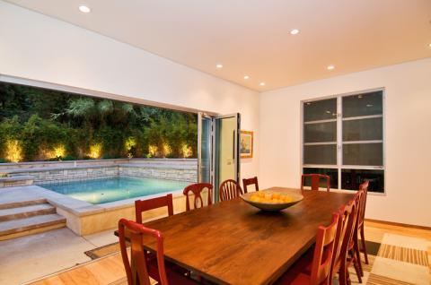 Modern Dining Room with view to outdoor pool in back yard