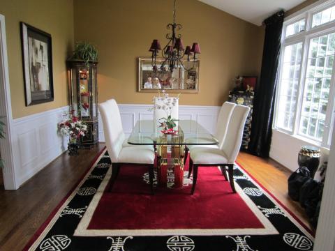 Eclectic Dining Room with red and black area rug