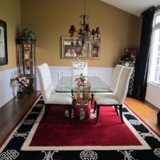 Eclectic Dining Room with red and black area rug