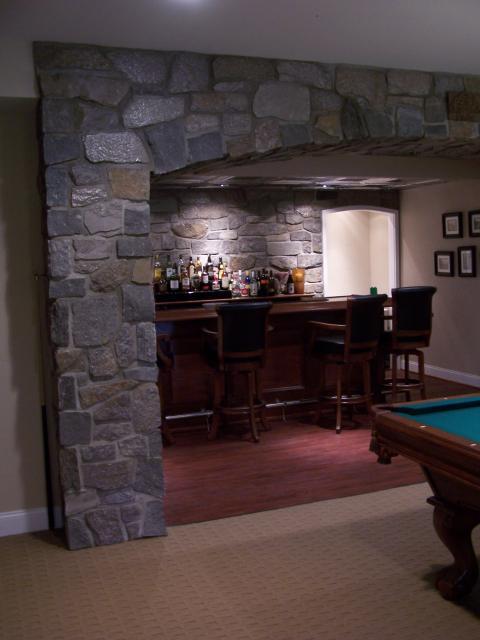 Traditional Basement with black leather bar stools